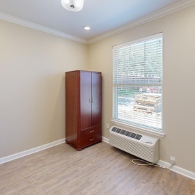 Gorgeous natural light in your living space a room with a window and a wood floor