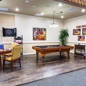 Everything within reach a room with a pool table and chairs
